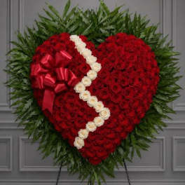 Heart-shaped standing floral tribute with red roses and white roses