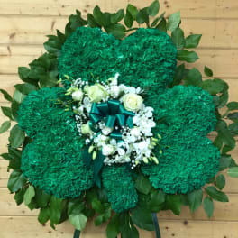 Green floral standing spray with white roses and ribbon