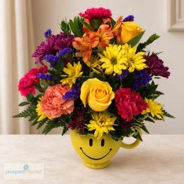 Colorful mixed bouquet in a yellow smiley-face mug