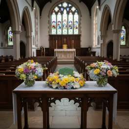 Floral arrangements on a table inside a church