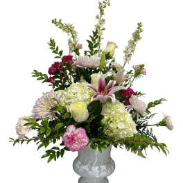 Pink and white mixed flower arrangement in a white vase