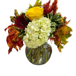 Yellow rose and white hydrangea arrangement in a glass vase