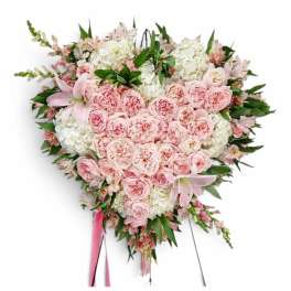 Heart-shaped pink and white floral spray on an easel