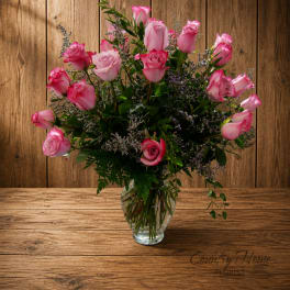 Pink roses arranged in a clear glass vase