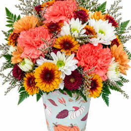 Mixed bouquet of chrysanthemums and carnations in a patterned vase