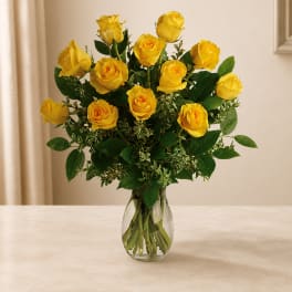 Yellow roses arranged in a clear glass vase