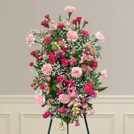 Tall standing floral spray with pink and white flowers on an easel
