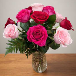Bouquet of pink and red roses in a clear glass vase