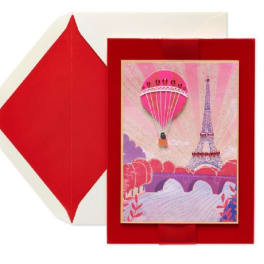 Red envelope-style card with a Paris-themed illustration