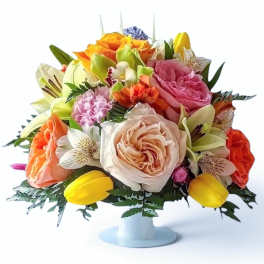Mixed bouquet of roses, tulips, and lilies in a white pedestal vase