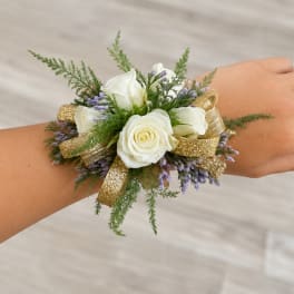 White rose wrist corsage with purple filler and gold ribbon