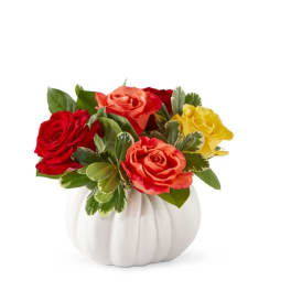Mixed roses in a white pumpkin-shaped vase