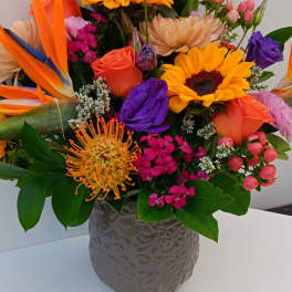 Colorful mixed bouquet in a gray textured vase