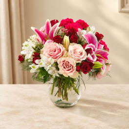 Bouquet of pink and red flowers in a clear glass vase