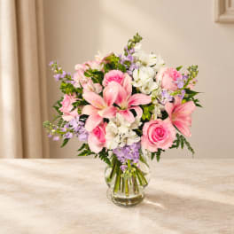 Pink and white mixed flower bouquet in a clear glass vase
