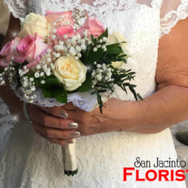 Bride holding a bouquet of pink and white roses