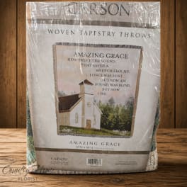Packaged woven tapestry throw with a church and hymn text