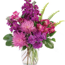 Purple and pink bouquet in a clear glass vase