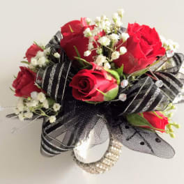 Red roses with white baby's breath and black ribbon accents