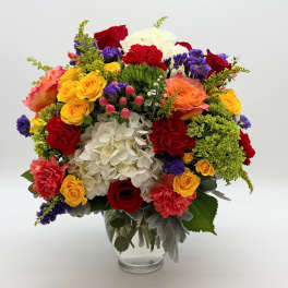 Colorful mixed flower bouquet in a clear glass vase