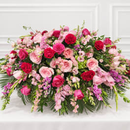 Large pink and red floral arrangement with roses and carnations