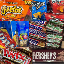 Assorted candy bars and snack bags stacked together