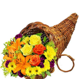 Colorful flower arrangement in a wicker horn-shaped basket