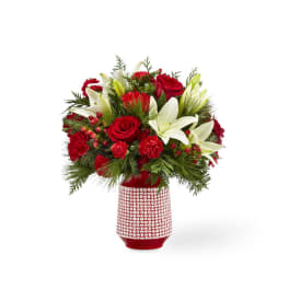 Red roses and white lilies in a red patterned vase
