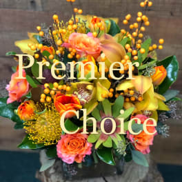 Mixed bouquet of orange and yellow flowers with berry stems