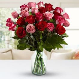 Bouquet of red and pink roses in a clear glass vase