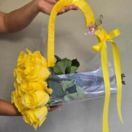 Yellow rose bouquet in a clear handbag-style wrap with ribbon