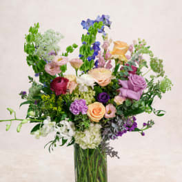 Mixed bouquet of colorful flowers in a clear glass vase