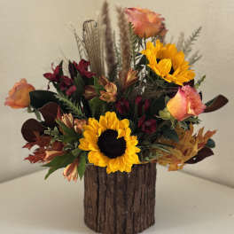 Sunflower and rose arrangement in a rustic wood container