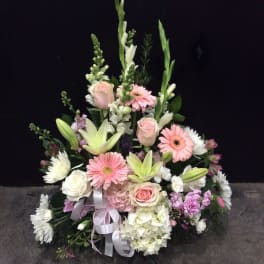 Tall pastel floral arrangement with roses, lilies, and gerbera daisies