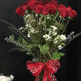 Bouquet of red roses with white filler flowers and a red heart ribbon