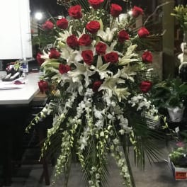 Tall standing floral spray with red roses and white lilies