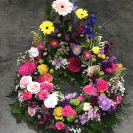 Colorful floral wreath with roses, daisies, and mixed blooms