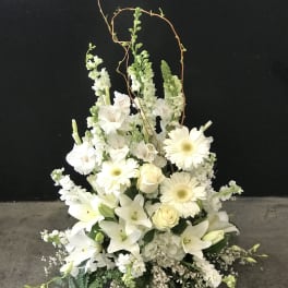 White floral arrangement with lilies, gerbera daisies, and roses