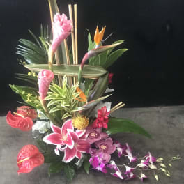Tropical floral arrangement with orchids, lilies, and bird-of-paradise