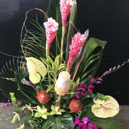 Tropical floral arrangement with pink ginger, anthuriums, and orchids