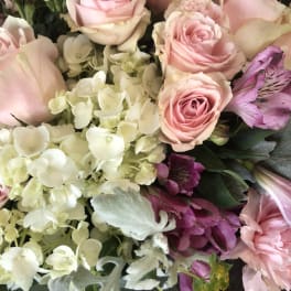 Pink roses with white hydrangeas and purple alstroemeria in a bouquet