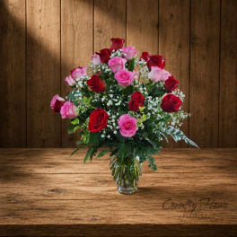 Bouquet of red and pink roses in a clear glass vase