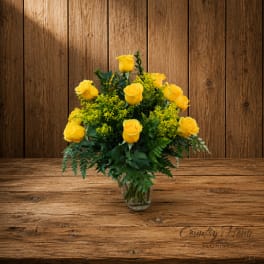 Yellow roses arranged in a clear glass vase