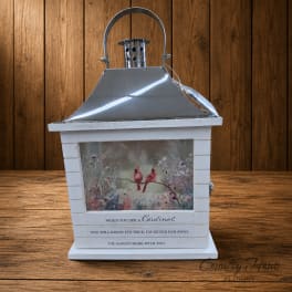 Decorative lantern with a cardinal illustration and memorial text