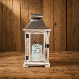 Wooden lantern with a candle inside on a wood surface