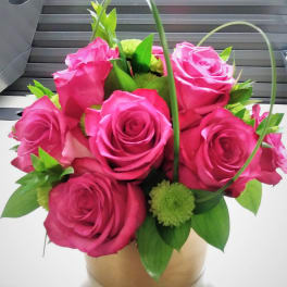 Pink rose bouquet in a gold box with green accents