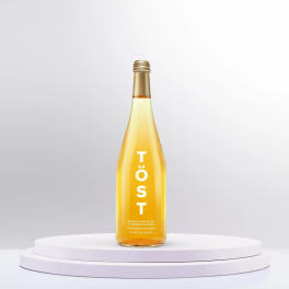 Bottle of sparkling white tea on a white pedestal