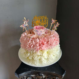 Pink and white flower cake with a Happy Birthday topper