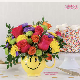 Bright mixed bouquet in a yellow smiley-face mug
