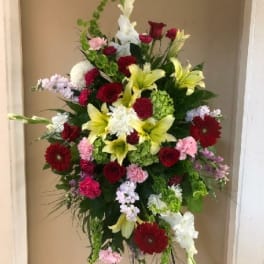 Tall mixed flower standing spray with red, white, pink, and yellow blooms